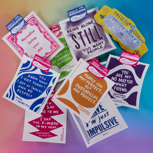 A collection of colorful Swedish dishcloths with bold, playful designs and motivational or humorous quotes, arranged on a gradient background.