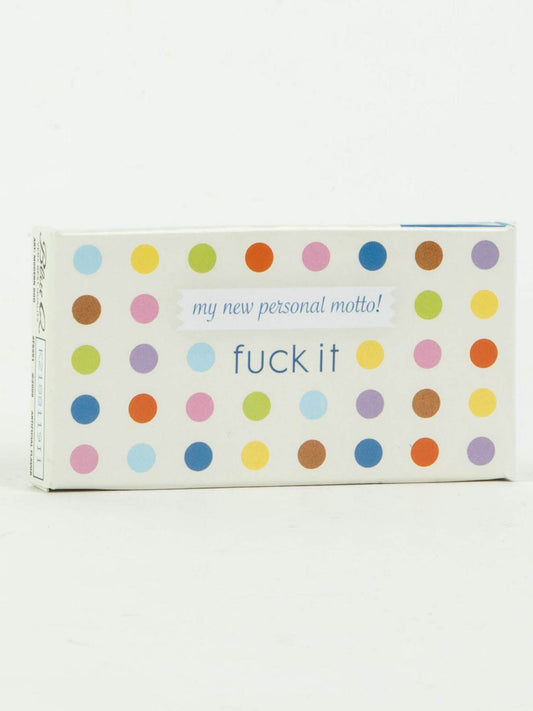 A rectangular box with colorful polka dots and the phrase "my new personal motto! fuck it" holds 8 pieces of vibrant fruit-flavored French candy. Product: Fuck It Gum by Blue Q. White background design.