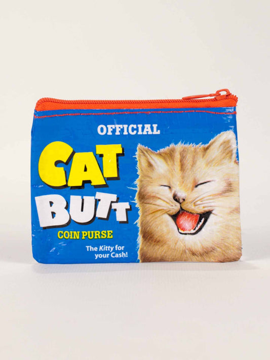 The Blue Q Cat Butt Coin Purse is a blue pouch with a red zipper, featuring a laughing cat and bold text: "Official Cat Butt Coin Purse – The Kitty for your Cash!" A quirky accessory celebrating all things cat butts.