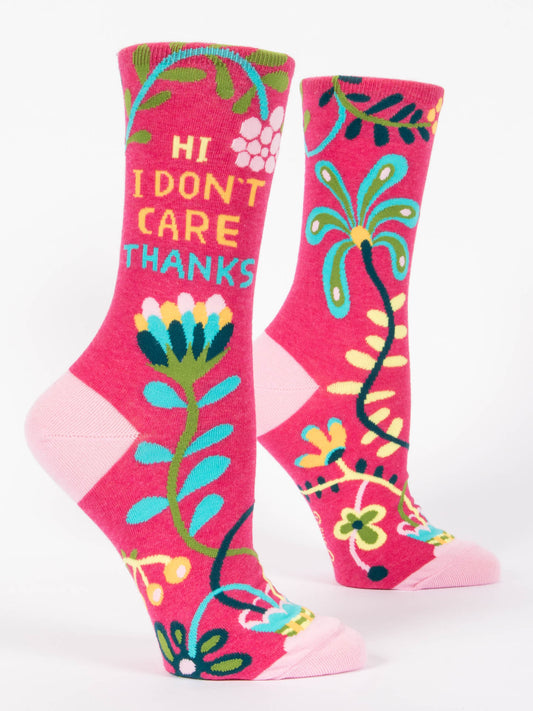 Blue Q’s Hi, I Don't Care, Thanks W-Crew Socks for women feature bright pink fabric with colorful floral patterns and “HI I DON’T CARE THANKS” in yellow and blue, plus light pink heels and toes. Soft nylon cotton ensures all-day comfort.