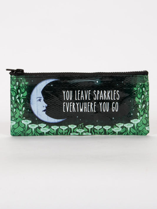 The Blue Q "You Leave Sparkles Everywhere You Go" Pencil Case features a crescent moon and floral design with the inspiring text—perfect for carrying your favorite glitter gel pens.