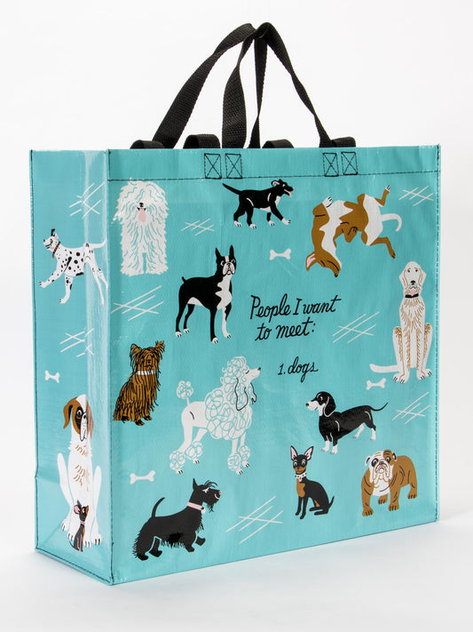 The Blue Q People I Want To Meet: Dogs Shopper is a teal reusable bag with black handles, dog illustrations, playful bone accents, and the text “People I want to meet: 1. dogs”—a stylish choice for any dog lover!.