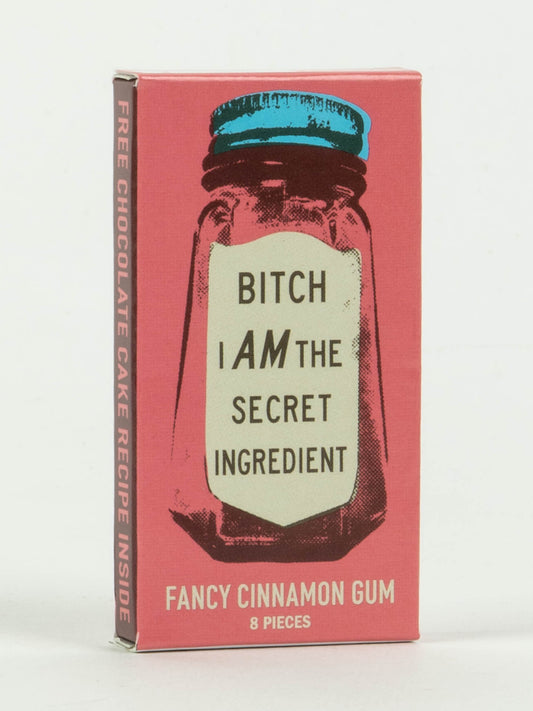 Blue Q’s “Bitch I Am The Secret Ingredient” Gum comes in a pink box with a spice jar illustration and cinnamon flavor, plus a free chocolate cake recipe inside.