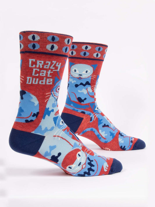 Blue Q Crazy Cat Dude M-Crew Socks feature red, blue, and navy designs with cartoon cats and "Crazy Cat Dude" on the side. Made from soft combed cotton, these playful novelty socks add fun to any outfit. Shown on a white background.