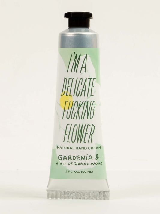 A 2 oz. tube of Blue Q’s “I’m a Delicate Fucking Flower” Natural Hand Cream features gardenia, a bit of sandalwood, and nourishing shea butter in pastel green and white packaging.