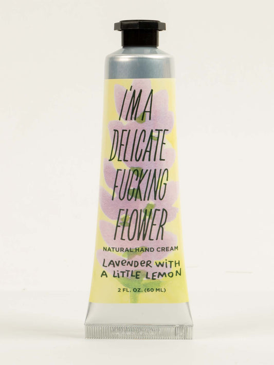 Blue Q’s “I’m a Delicate Fucking Flower” Natural Hand Cream—lavender with a little lemon—comes in a 2 fl. oz. tube featuring pastel colors and bold, playful text on the label.