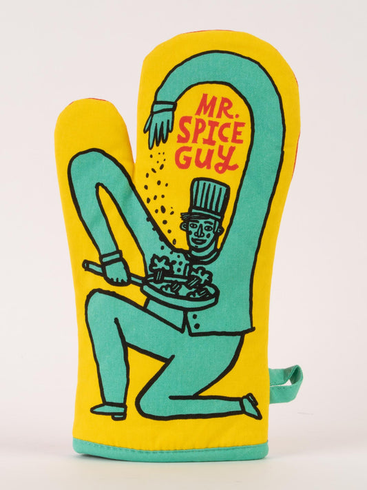 The Blue Q Mr. Spice Guy Oven Mitt is yellow and shows a cartoon chef with a magically long arm sprinkling spices on food, with "MR. SPICE GUY" in red above him.
