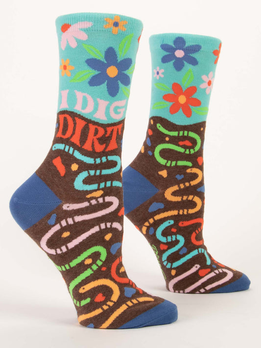 Blue Q’s I Dig Dirt W-Crew Socks feature bold petunias and “I DIG DIRT” on a turquoise background, with brown soil and vibrant worm designs—perfect for gardening enthusiasts.