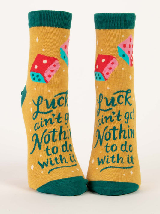 Blue Q’s Luck Ain't Got Nothin' To Do With It W-Ankle Socks feature a yellow combed cotton base with green cuffs, heels, and toes, colorful dice accents, and the bold phrase "Luck ain't got nothin' to do with it.