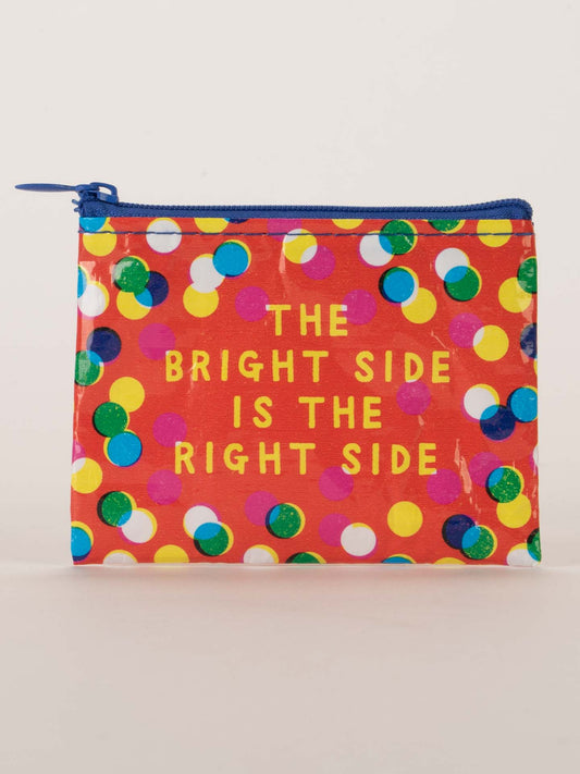The Bright Side Is The Right Side Coin Purse by Blue Q features vibrant dots on red and cheerful yellow text, THE BRIGHT SIDE IS THE RIGHT SIDE—perfect for bringing fun, positive vibes to your day.