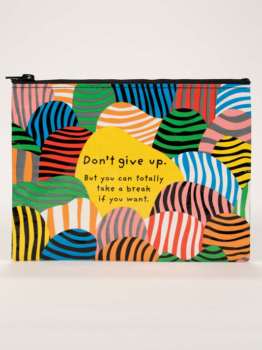The Blue Q "Don't Give Up. But You Can Totally Take A Break If You Want." Zipper Pouch features vibrant overlapping arches and stripes—a cheerful accessory or library decor with an encouraging message at its center.