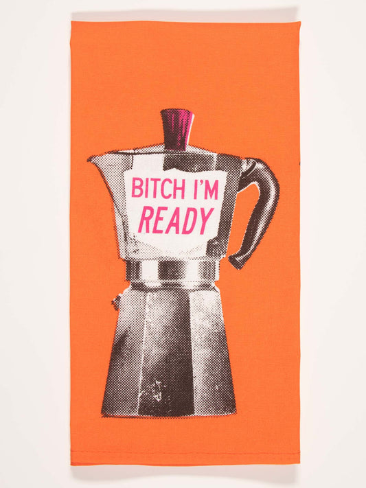 The Blue Q "Bitch I Am Ready" Dish Towel is orange with a black and white moka pot featuring a magenta top and a bold magenta label that reads “BITCH I’M READY”—adding stylish attitude to your morning routine.