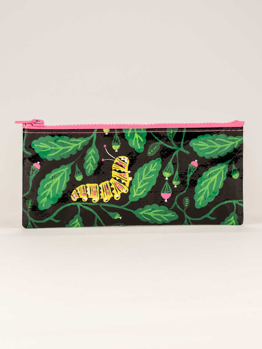 The Blue Q Caterpillar Pencil Case is a rectangular novelty pouch with a pink zipper, featuring green leaves, purple buds, and a yellow and black caterpillar on a black background.