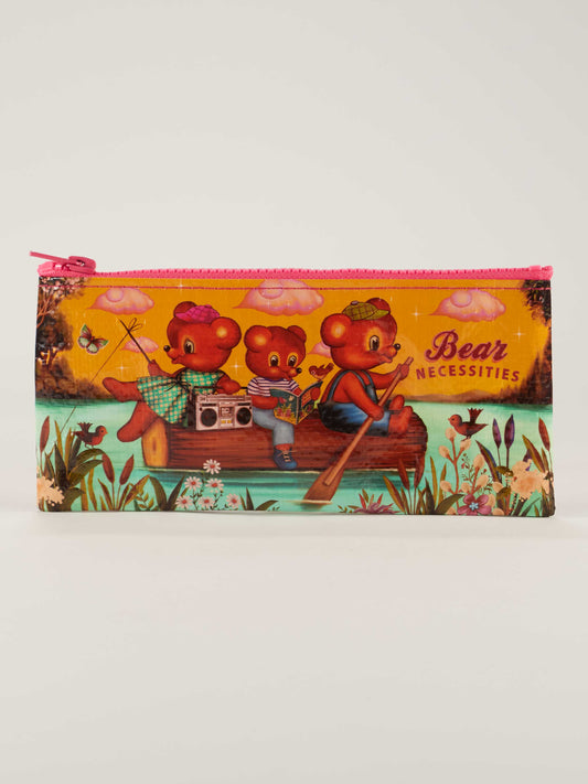 The Bear Necessities Pencil Case by Blue Q features three cartoon bears on a log raft—one paddling, one with a boom box, and one in a hat—amid flowers, comic books, and a river scene. Text reads "Bear Necessities.
