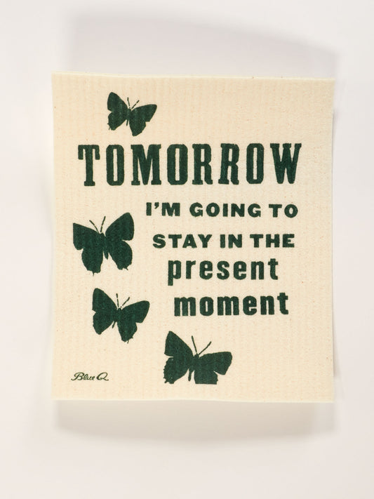 The Blue Q "Tomorrow I'm Going To Stay In The Present Moment" Swedish Dishcloth is a beige, machine washable cloth featuring black butterfly illustrations and the phrase: TOMORROW I’M GOING TO STAY IN THE present moment.