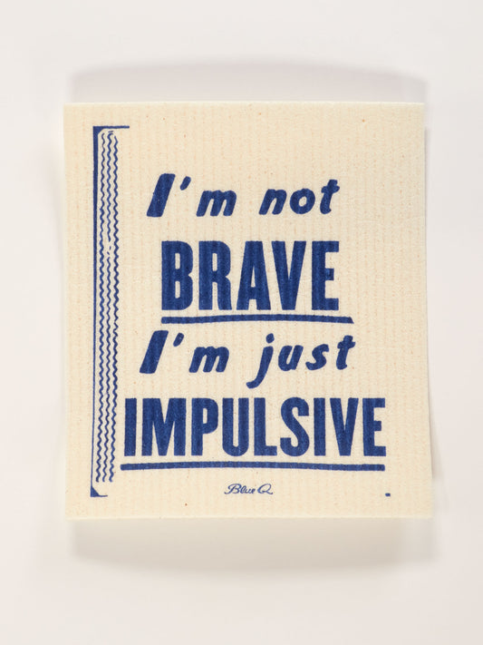 The Blue Q "I'm Not Brave I'm Just Impulsive" Swedish Dishcloth is beige, compostable, machine washable, and super-absorbent, featuring bold blue text and decorative lines on the left.