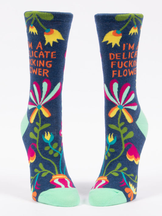 Blue Q’s I’m A Delicate Fucking Flower W-Crew Socks feature comfy white fabric, bold text, floral patterns, and green heels and toes.