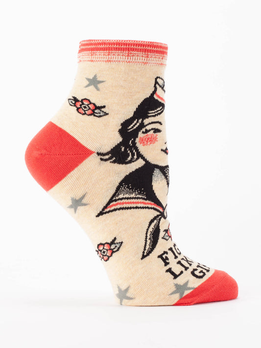 Blue Q’s Fight Like A Girl W-Ankle Socks are beige women’s socks with red accents, featuring a vintage-inspired design of a strong woman in a sailor hat, star and flower motifs, and soft combed cotton for all-day comfort.