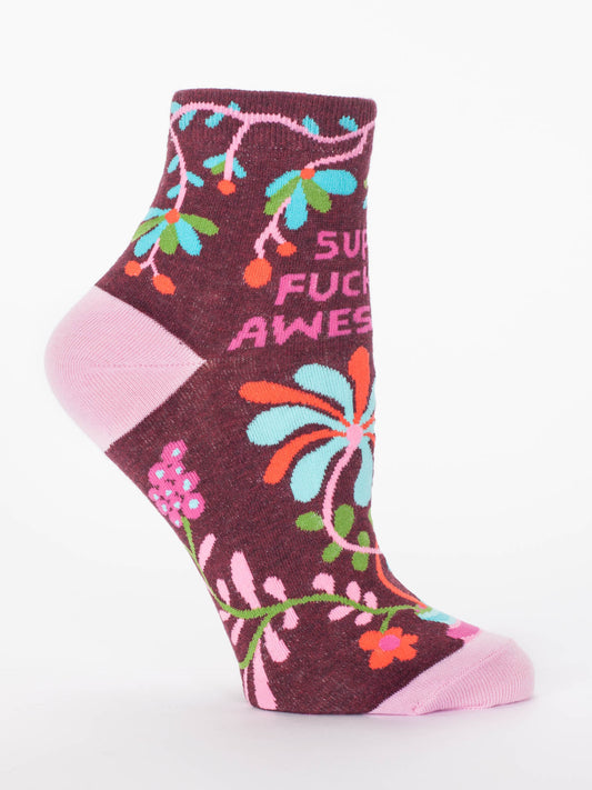 The Blue Q Super Fucking Awesome W-Ankle Socks feature colorful maroon floral designs, pink toe and heel accents, and bold “SUPER FUCKING AWESOME” lettering. Made from a comfy nylon-cotton blend.