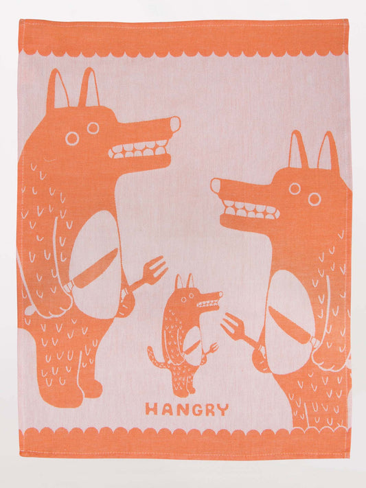 The Blue Q Hangry Dish Towel showcases two big, cartoon wolves and a smaller wolf holding utensils with “HANGRY” below—a fun, playful design perfect for kitchen laughs.