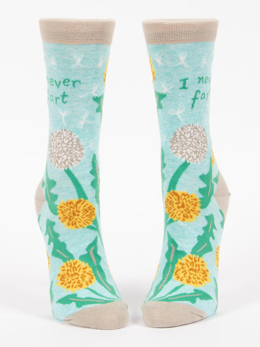 Blue Q I Never Fart W-Crew Socks: Light blue, soft combed cotton with beige toes, heels, and cuffs. Features yellow and white dandelions, green leaves, and "I never fart" text near the top.