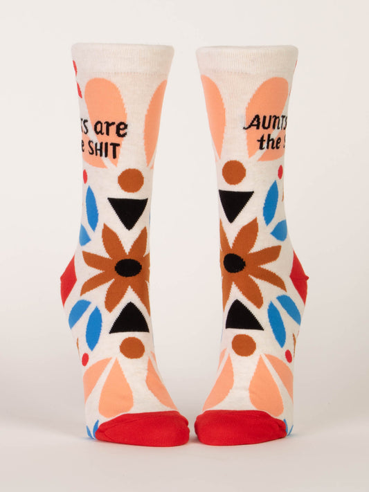 Blue Q Aunts Are The Shit W-Crew Socks feature geometric peach, blue, black, and brown patterns on soft combed cotton with spandex and display “Aunts are the SHIT” text on a white background near the top.
