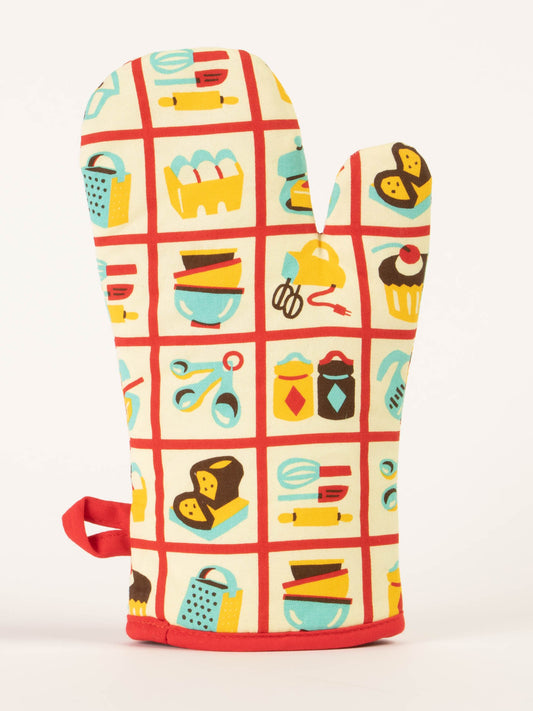 The Blue Q "Baked Goods? I Make Baked Greats!" Oven Mitt features a red grid pattern with fun kitchen-themed illustrations on a cream background—a stylish way to show off your baking confidence.