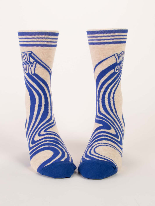 The Blue Q What A Guy M-Crew Socks are cream-colored cotton socks with blue toes, heels, swirling patterns, bold "WHAT A GUY" text, and striped tops—crafted from soft combed cotton for all-day comfort.