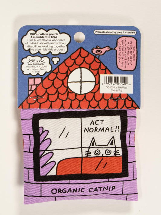 The Blue Q “Busted! Oh Shit, It’s The Fuzz!” Catnip Toy features a cat peeking from a window under ACT NORMAL!!, in packaging labeled ORGANIC CATNIP with a red-roofed house, promoting healthy play and exercise for pets.