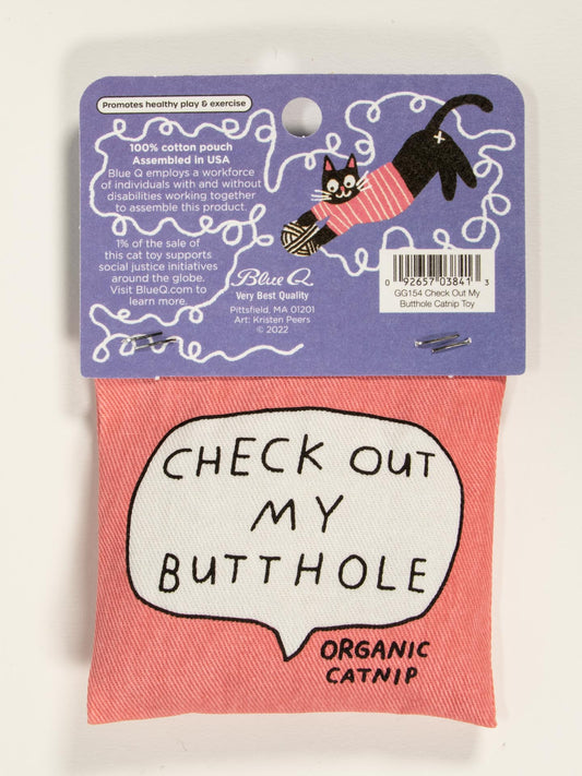 The Blue Q "Check Out My Butthole Catnip Toy" is a pink organic catnip pouch with a speech bubble reading CHECK OUT MY BUTTHOLE ORGANIC CATNIP, featuring a cartoon cat and healthy play on vibrant purple packaging.