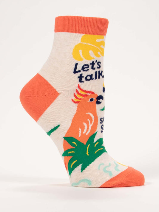 Let’s Talk Some Shit W-Ankle Socks by Blue Q feature a beige combed cotton base with an orange heel and toe, plus a colorful parrot, green leaves, and bold “Let’s talk” text for a playful, tropical vibe.