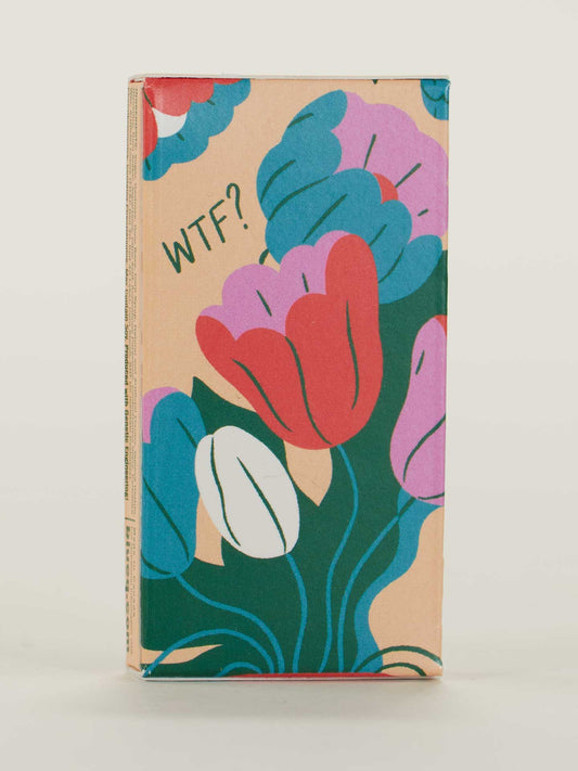 A rectangular box of Blue Q's "Menopause. What The Fuck? Gum," featuring bold, colorful floral designs in red, pink, purple, blue, and green with "WTF?" near the top left on a soft beige background.