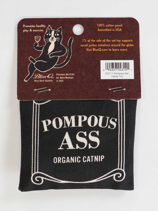 A black cotton pouch labeled Pompous Ass Catnip Toy from Blue Q hangs on a brown tag with a cartoon cat exercising, highlights social justice support, product details, and makes a fun toy for cat exercise.