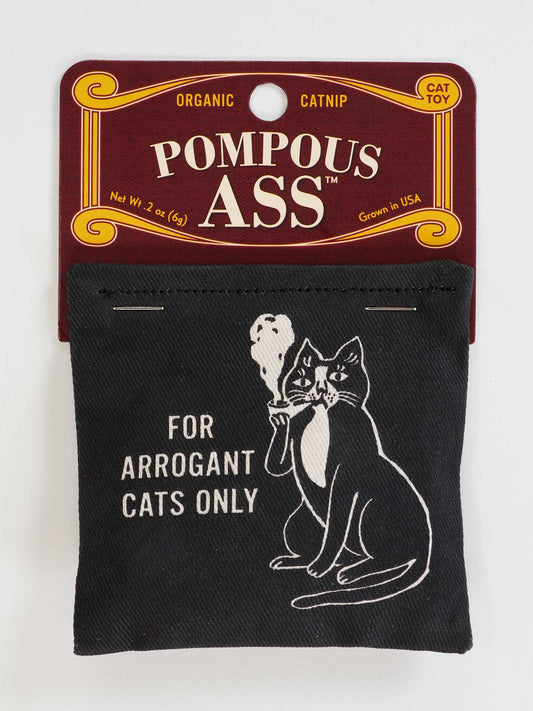 The Blue Q Pompous Ass Catnip Toy features a pipe-smoking cat with "FOR ARROGANT CATS ONLY" on black fabric. Filled with organic catnip, it’s perfect for playful cat exercise. Comes in brown and gold packaging.