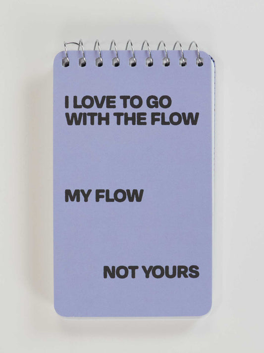 The Blue Q "I Love To Go With The Flow. My Flow, Not Yours" 3x5 Spiral Notebook features a lavender cover with bold black text—perfect for expressing your own flow.