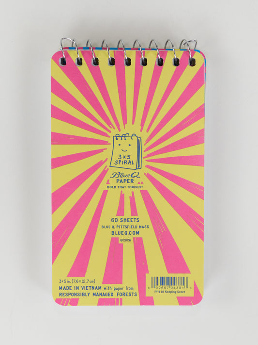 Keep score in style with Blue Q’s “Yes, I’m Keeping Score. Also, I Make The Rules Which Are Subject To Change. Without Notice.” 3x5 Spiral Notebook—60 sheets with a yellow cover and bold pink rays. Made in Vietnam.