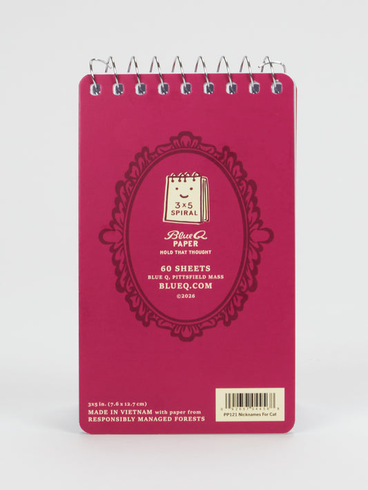 The Nicknames For My Cat Vol. 5 3x5 Spiral Notebook by Blue Q is a red, spiral-bound notepad featuring whimsical cover illustrations. This compact notebook contains 60 sheets, with a barcode and responsibly sourced paper information printed at the bottom.