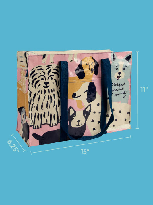 The Blue Q Happy Dogs Shoulder Tote features playful dog illustrations and blue handles. Measuring 15" wide, 11" tall, and 6.25" deep, it's shown against a solid light blue background for a vibrant look.