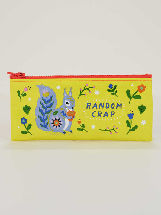 The Blue Q Random Crap Pencil Case is yellow with a red zipper, features a blue squirrel with an acorn amid flowers and leaves, and has "RANDOM CRAP" in white. Made from recycled material.