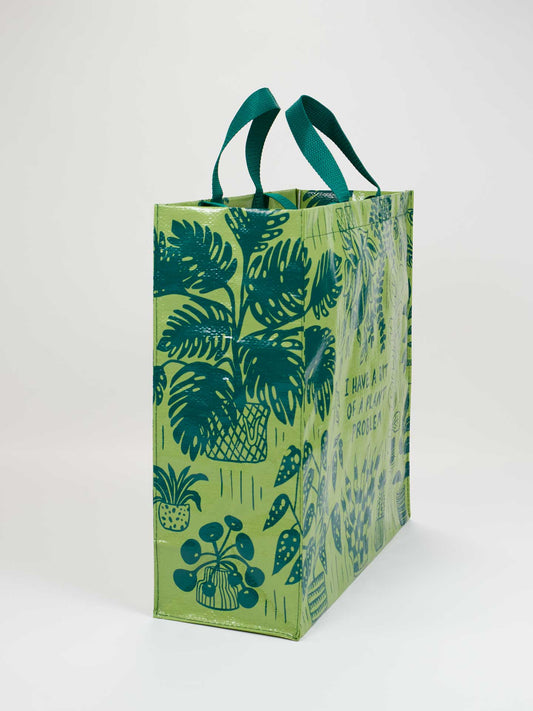 The Blue Q "I Have A Bit Of A Plant Problem Shopper" is a reusable bag with green handles, featuring dark green potted plant illustrations on a light green background—ideal for any plant lover.