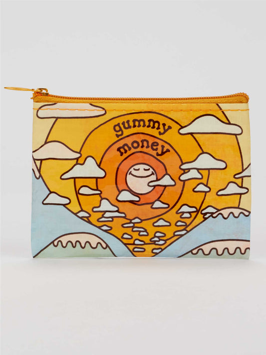 Introducing the Gummy Money Coin Purse by Blue Q—a compact, zippered pouch adorned with a cheerful retro sun, fluffy clouds, and "gummy money" playfully lettered on the front. Crafted from recycled material, this mellow accessory features a soothing palette of yellow, orange, and blue shades.