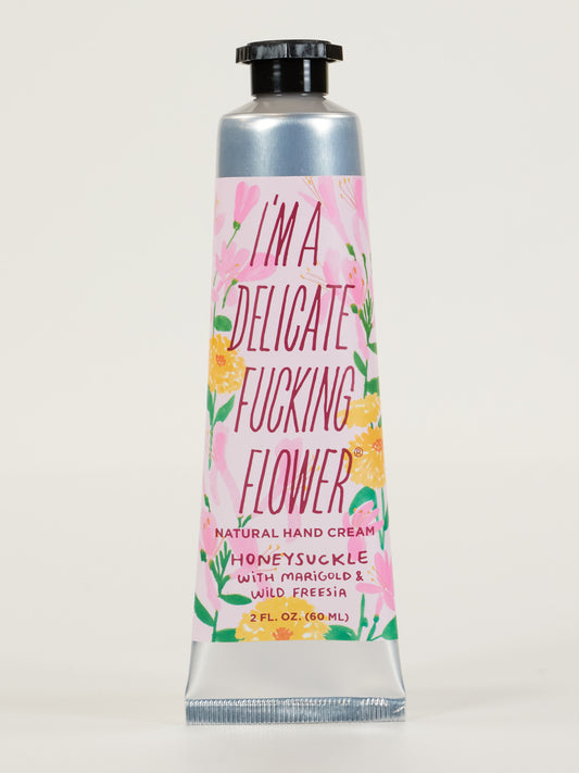 Blue Q’s I’m a Delicate Fucking Flower Natural Hand Cream—Honeysuckle with Marigold & Wild Freesia comes in a silver 2 fl. oz. tube with a pink floral label and contains shea butter to nourish your hands.