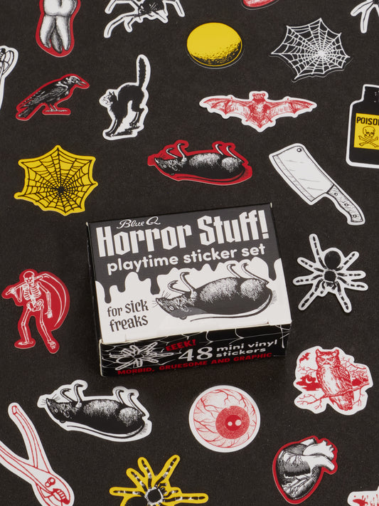 A box labeled *Horror Stuff Playtime Sticker Set* from Blue Q sits on a black background, surrounded by a grotesque collection of horror-themed stickers featuring spiders, bats, cats, cleavers, webs, and eyeballs.