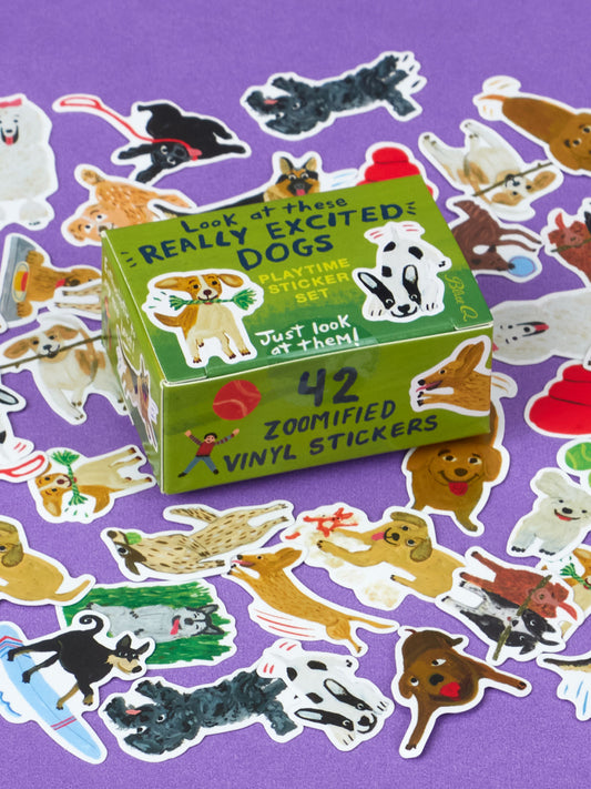A small green box labeled Look At These Really Excited Dogs Playtime Sticker Set, surrounded by stickers of cartoon dogs in playful poses that look like cute plush toys, set against a purple background.
