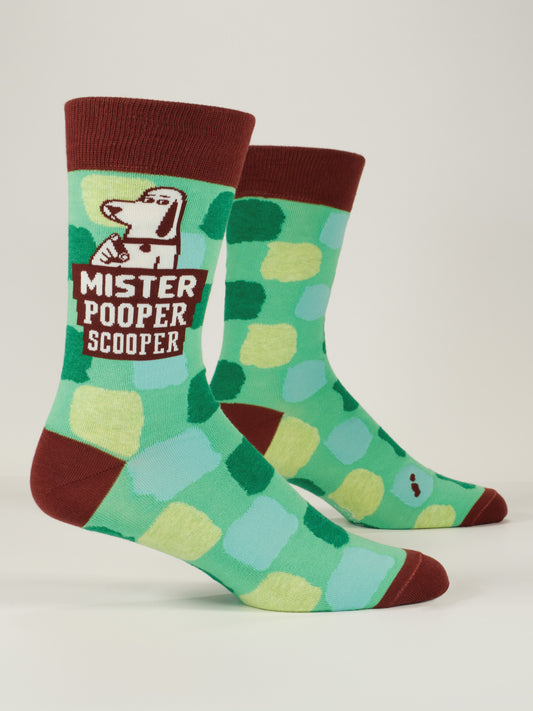 Blue Q Mister Pooper Scooper M-Crew Socks feature combed cotton with green and teal squares, maroon accents, and a cartoon dog above the words “Mister Pooper Scooper” on the side.