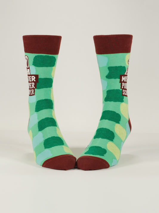 Blue Q's Mister Pooper Scooper M-Crew Socks are combed cotton crew socks with a green and blue checkered pattern, dark red heels, toes, cuffs, and feature “Mister Pooper Scooper” with a smiling cartoon character near the top.