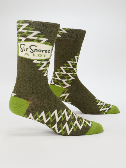 Blue Q’s Sir Snores A Lot M-Crew Socks are green combed cotton men's socks with white zigzag patterns and light green accents, featuring a "Sir Snores A Lot" patch near the top.