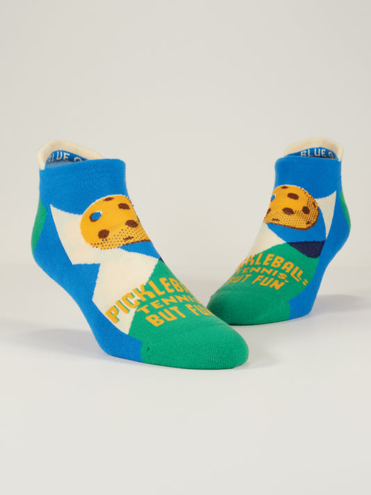 Pickleball: Tennis, But Fun Sneaker Socks by Blue Q—blue, green, and white ankle socks with a cartoon paddle and ball, shock-absorbing cushion, and yellow “PICKLEBALL: TENNIS BUT FUN!” text on the front.