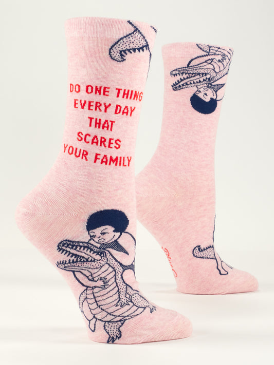 Blue Q's Do One Thing Every Day That Scares Your Family W-Crew Socks: pink combed cotton socks with a cartoon person wrestling an alligator and bold red text, "DO ONE THING EVERY DAY THAT SCARES YOUR FAMILY.