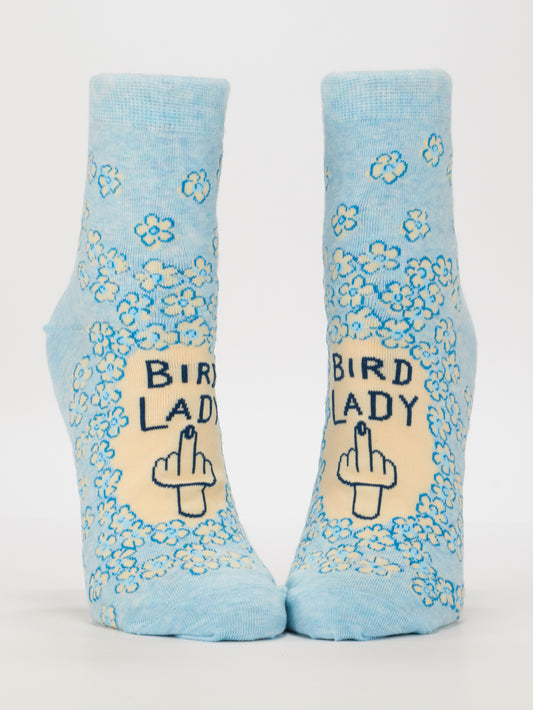 Blue Q Bird Lady W-Ankle Socks: Light blue combed cotton socks with white and blue flowers, featuring “BIRD LADY” above a hand showing the middle finger, displayed on a plain white background.